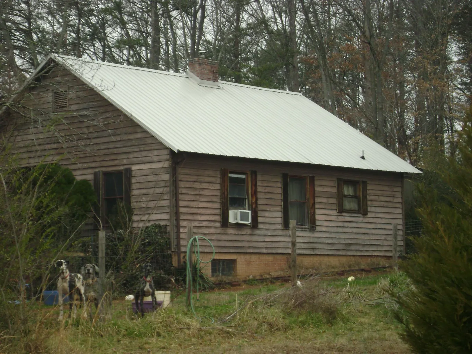 White metal roof on an old wood sided farmhouse, from a Metal Roof Installation job in Old Bethpage